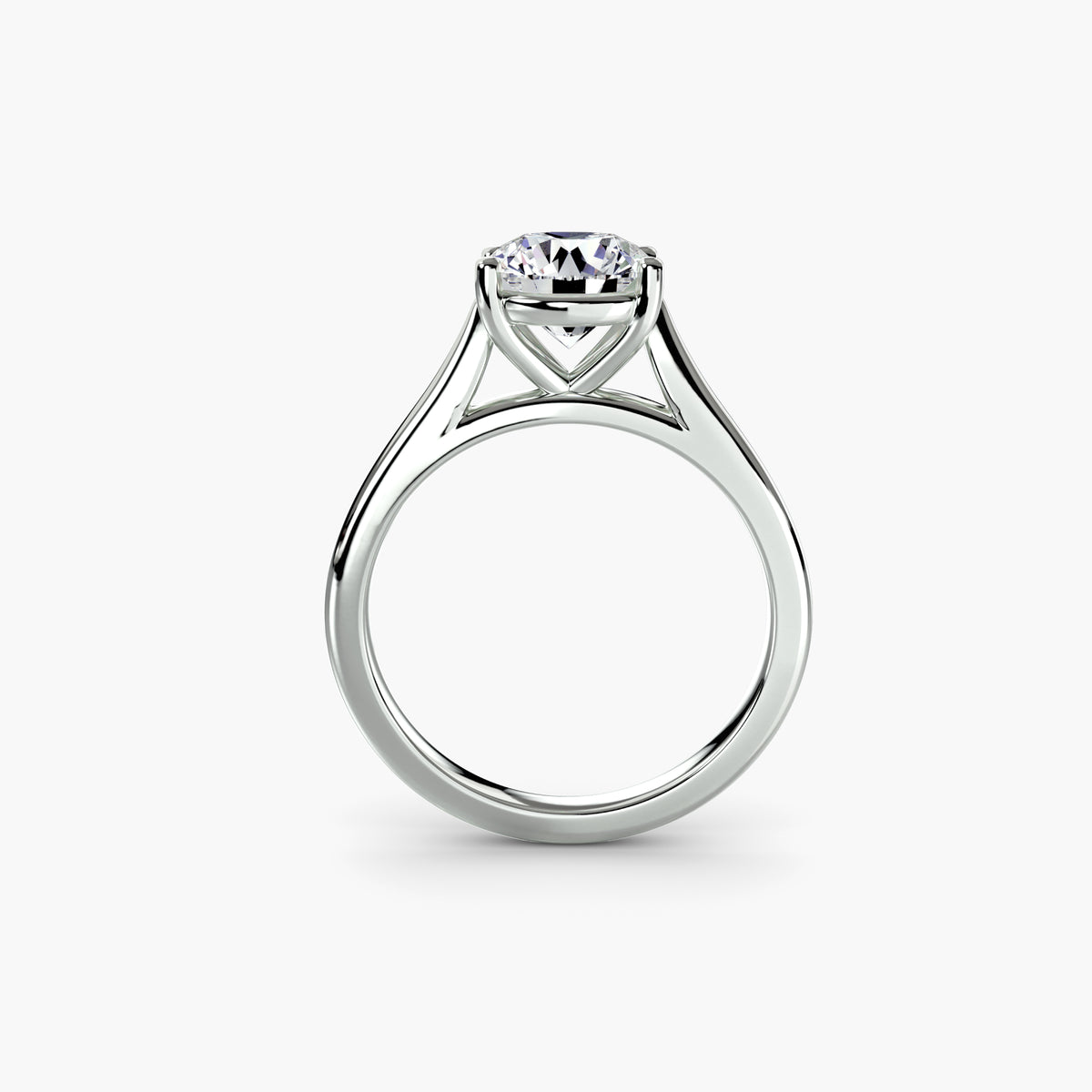 Profile view of The Amélie solitaire engagement ring with raised prong setting