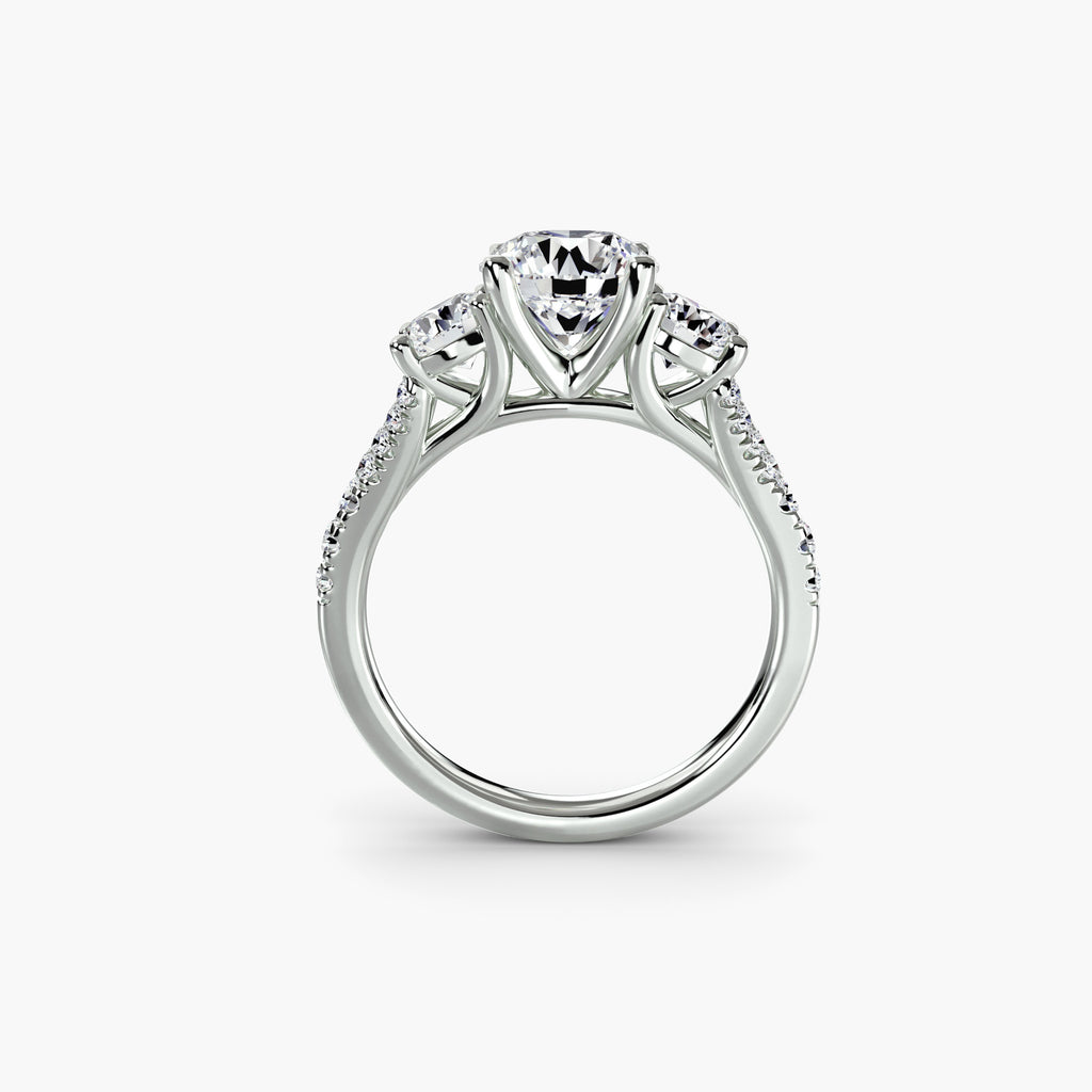 Profile view of delicate pavé three-stone engagement ring – The Violette