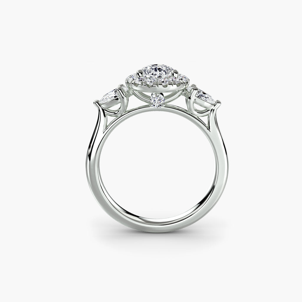 Profile view of The Clarimond three-stone halo engagement ring with pear-shaped side diamonds