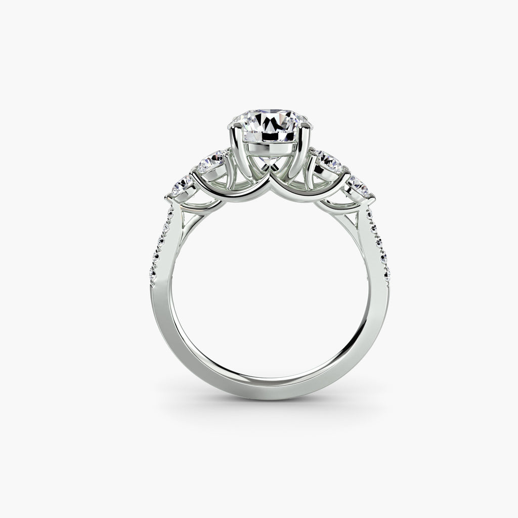 Profile view of The Alessandra five-stone engagement ring with pavé diamond band