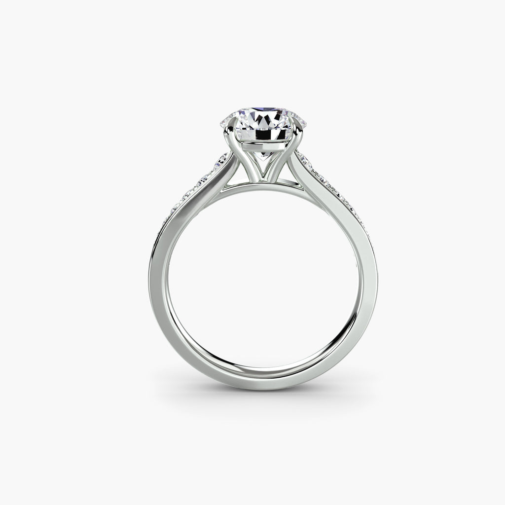Profile view of The Madeleine engagement ring with channel-set diamond shoulders