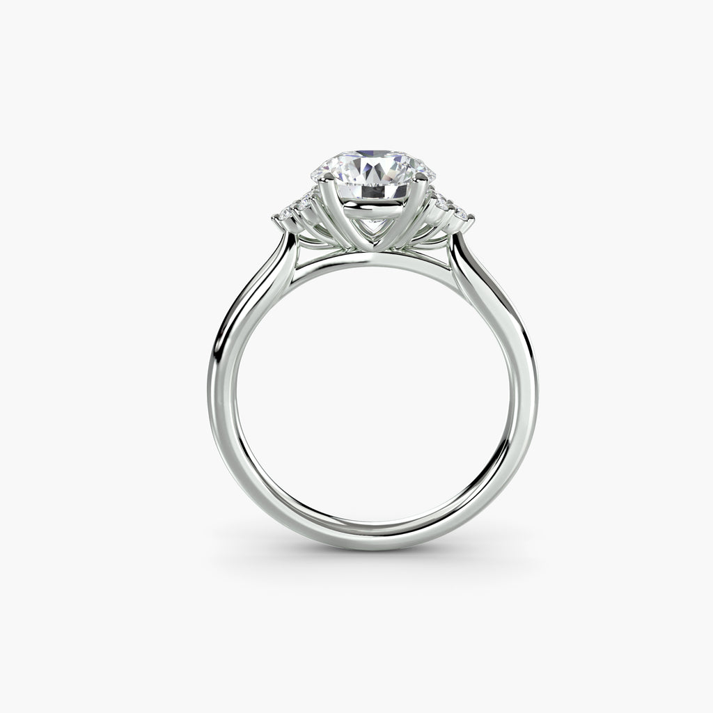 Profile view of The Céleste solitaire engagement ring with clustered diamond side stones