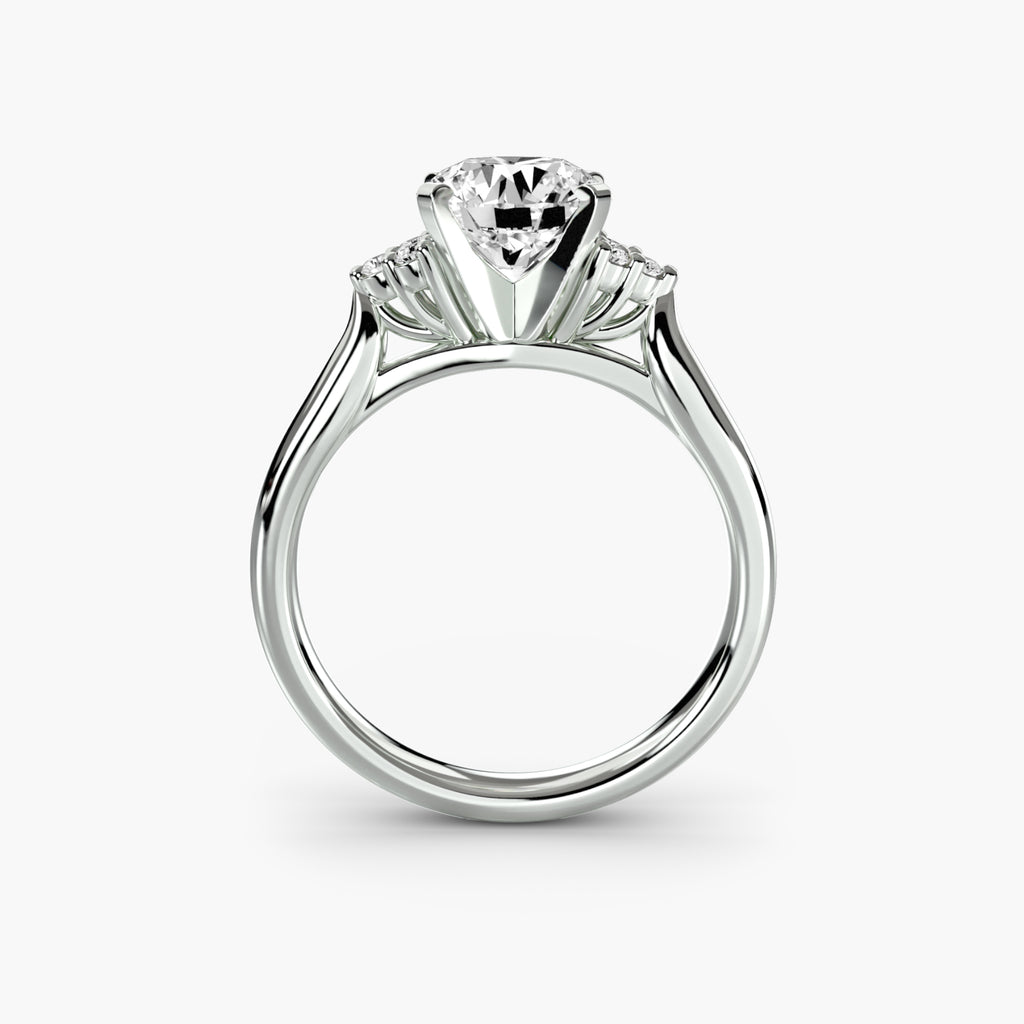 Profile view of The Rosalie solitaire engagement ring with petite diamond shoulder accents