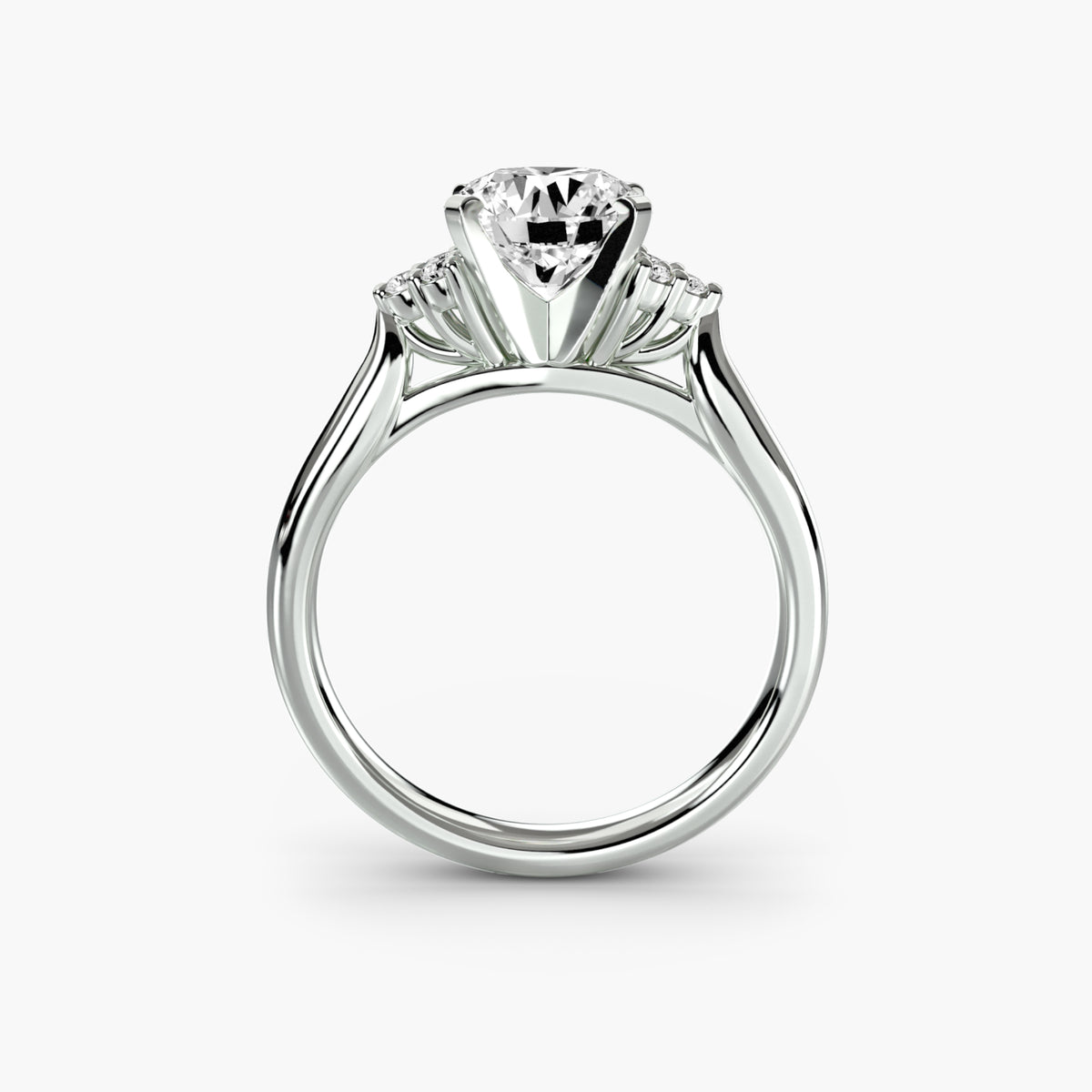 Profile view of The Rosalie solitaire engagement ring with petite diamond shoulder accents